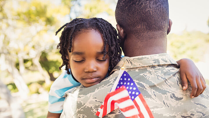 A child hugging veteran parent.